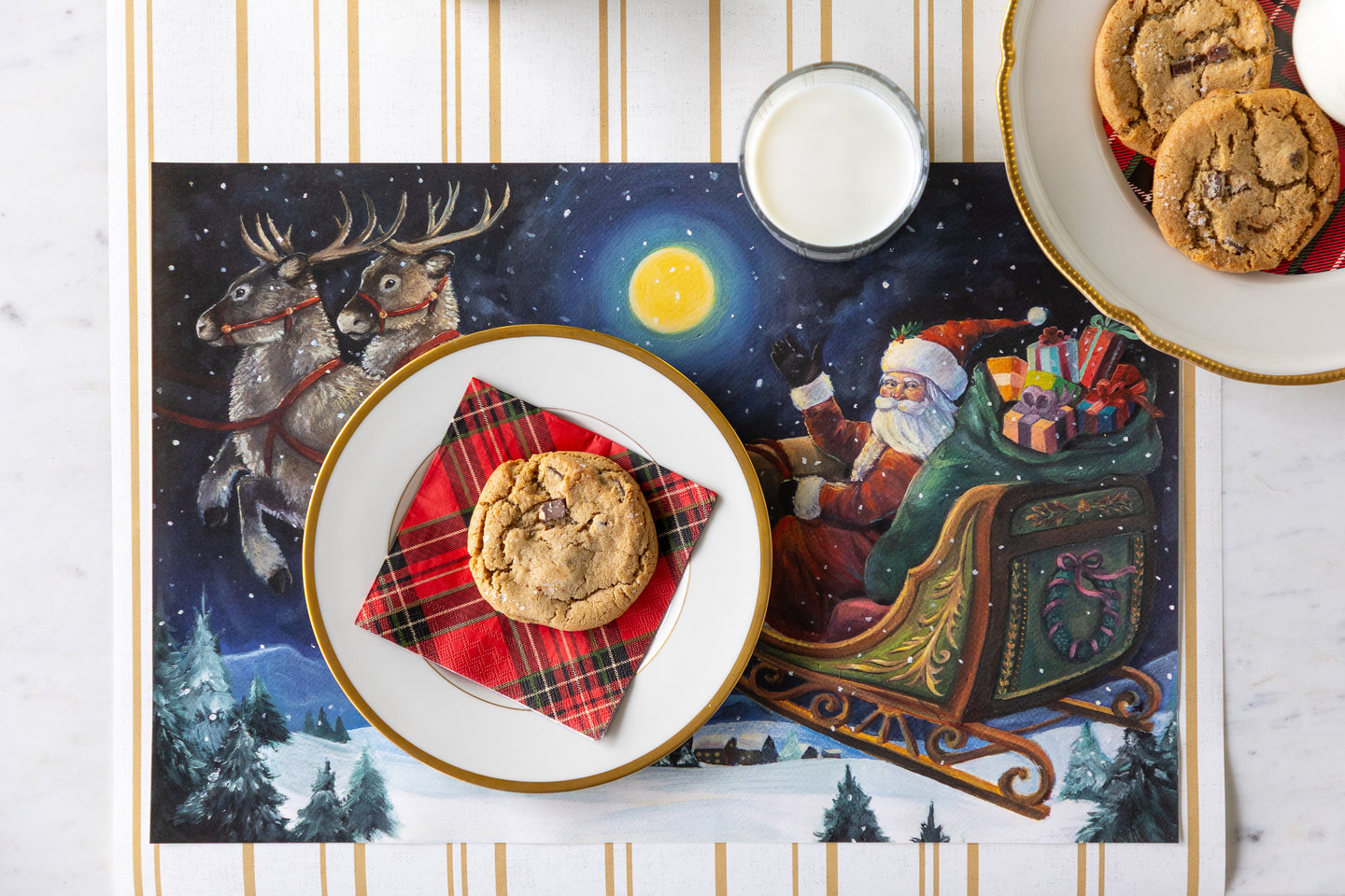 A festive place setting featuring the Sleigh Ride Placemat with plates of cookie and a cup of milk on the Antique Gold Stripe Runner.