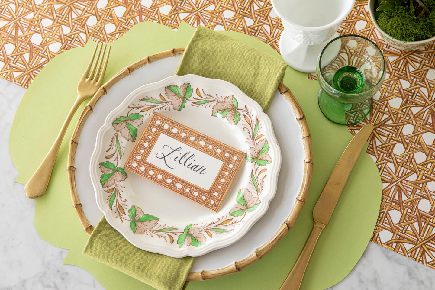 A spring place setting for one with the Die-cut Green French Frame Placemat and Rattan Runner underneath.