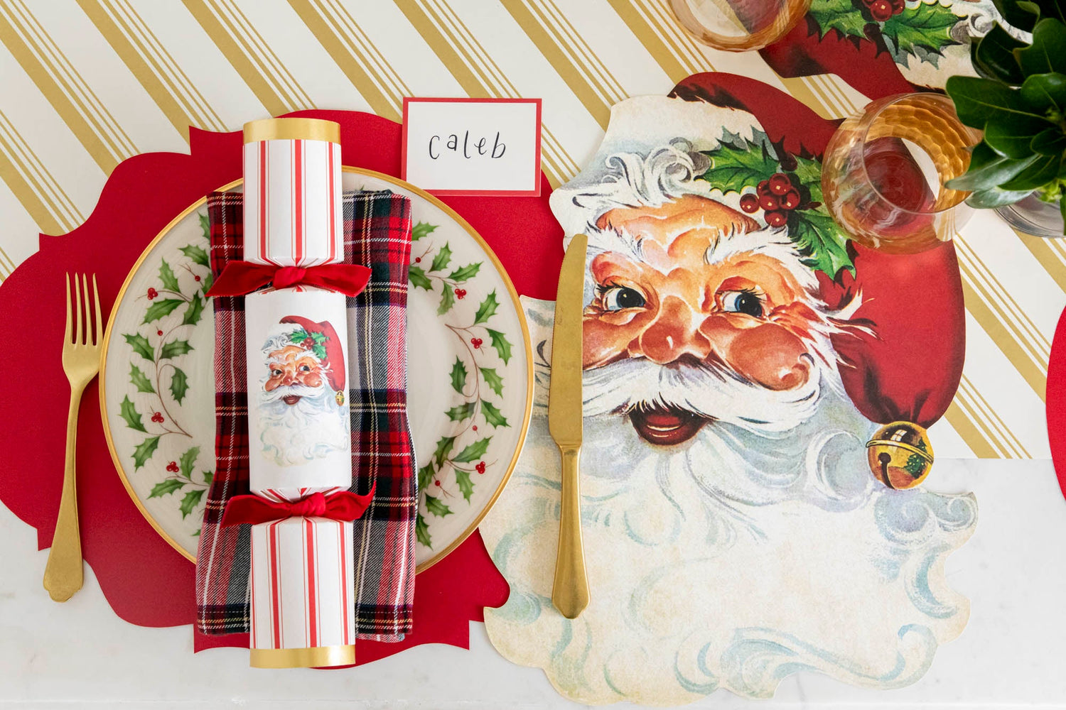 An elegant table setting featuring the Merry &amp; Bright Runner underneath the Die-cut Vintage Christmas Tree Placemat and Stocking Table Accent on a set of dinner plates.