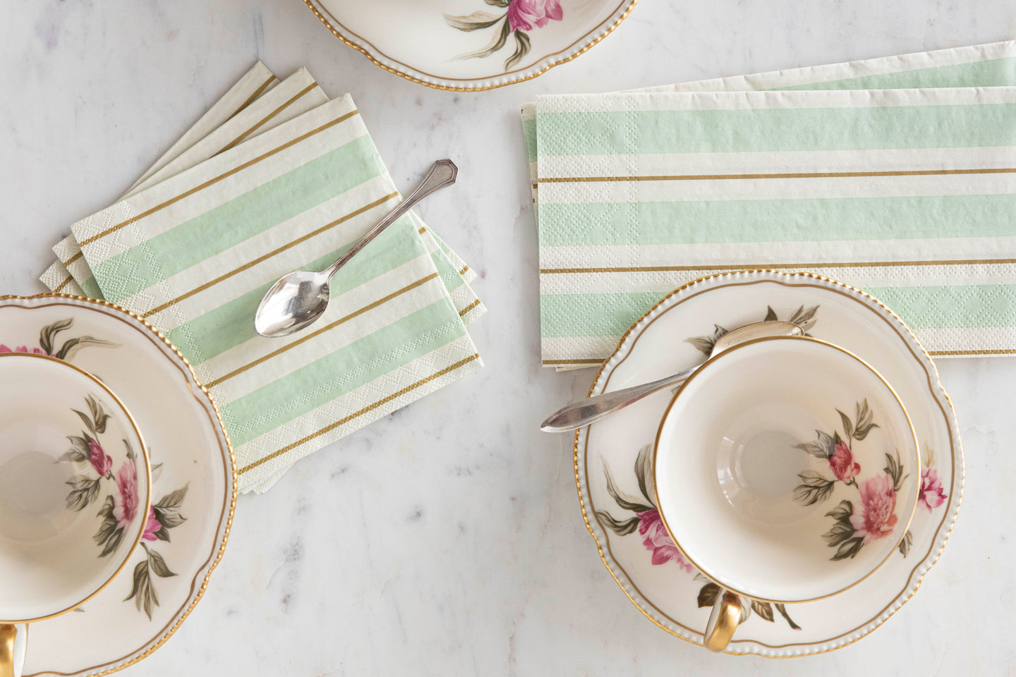 Seafoam & Gold Awning Stripe Napkins next to tea cups on top of saucers.
