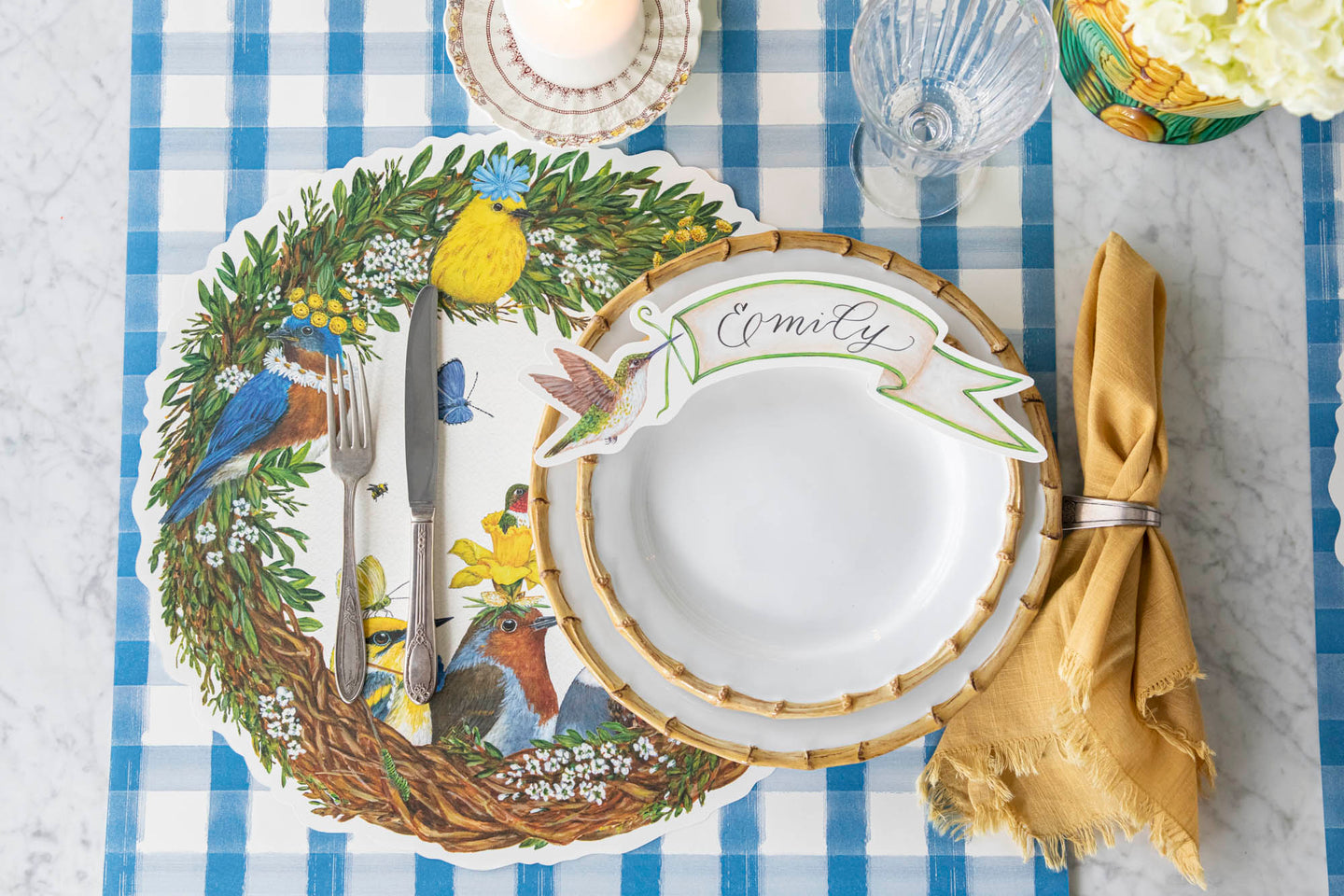 An elegant place setting featuring Vicki Sawyer's Die-cut Songbird Wreath Placemat and Hummingbird Table Accent.