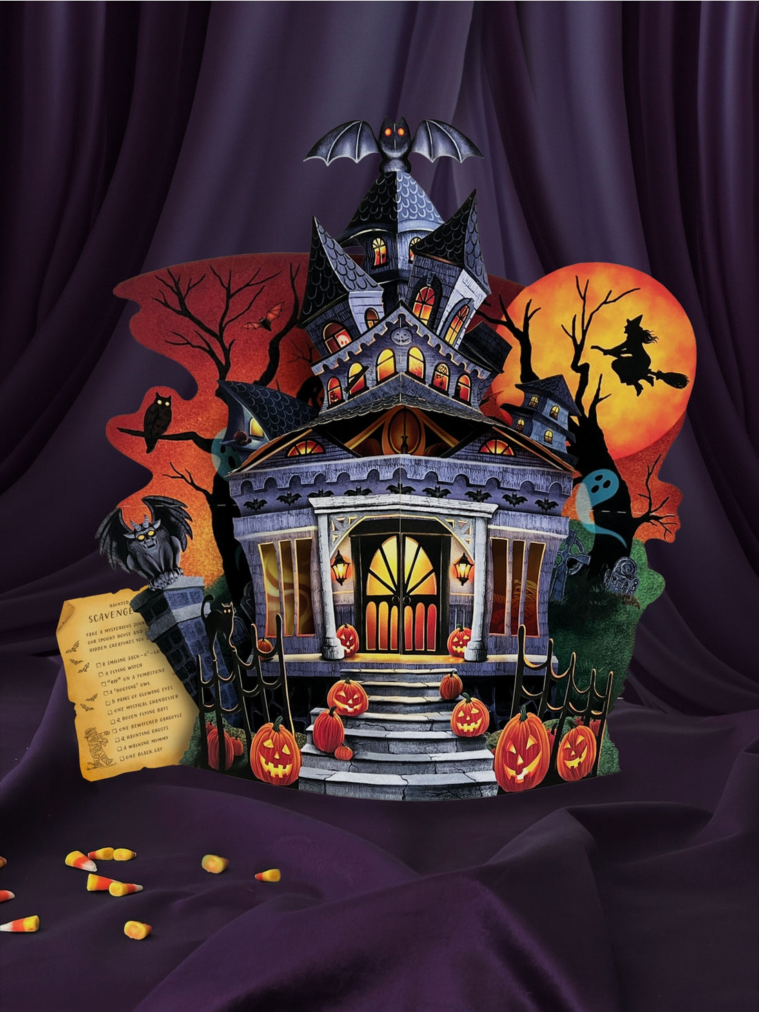 Halloween-themed house with pumpkins, bats, and a witch on a broomstick against a dark background.
