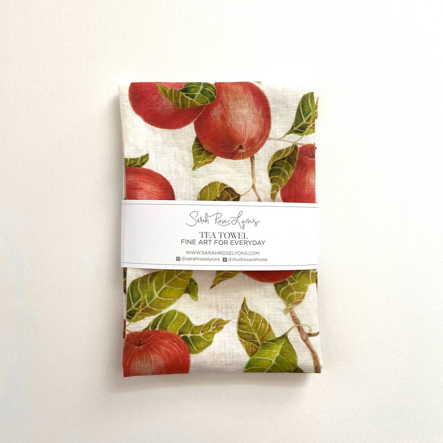 Tea towel with apple design on a white background