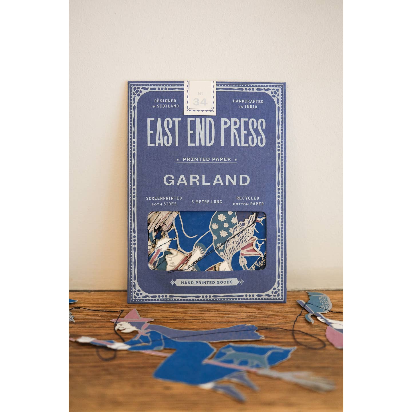 Front of package for the witches garland surrounded by the witches garland. 