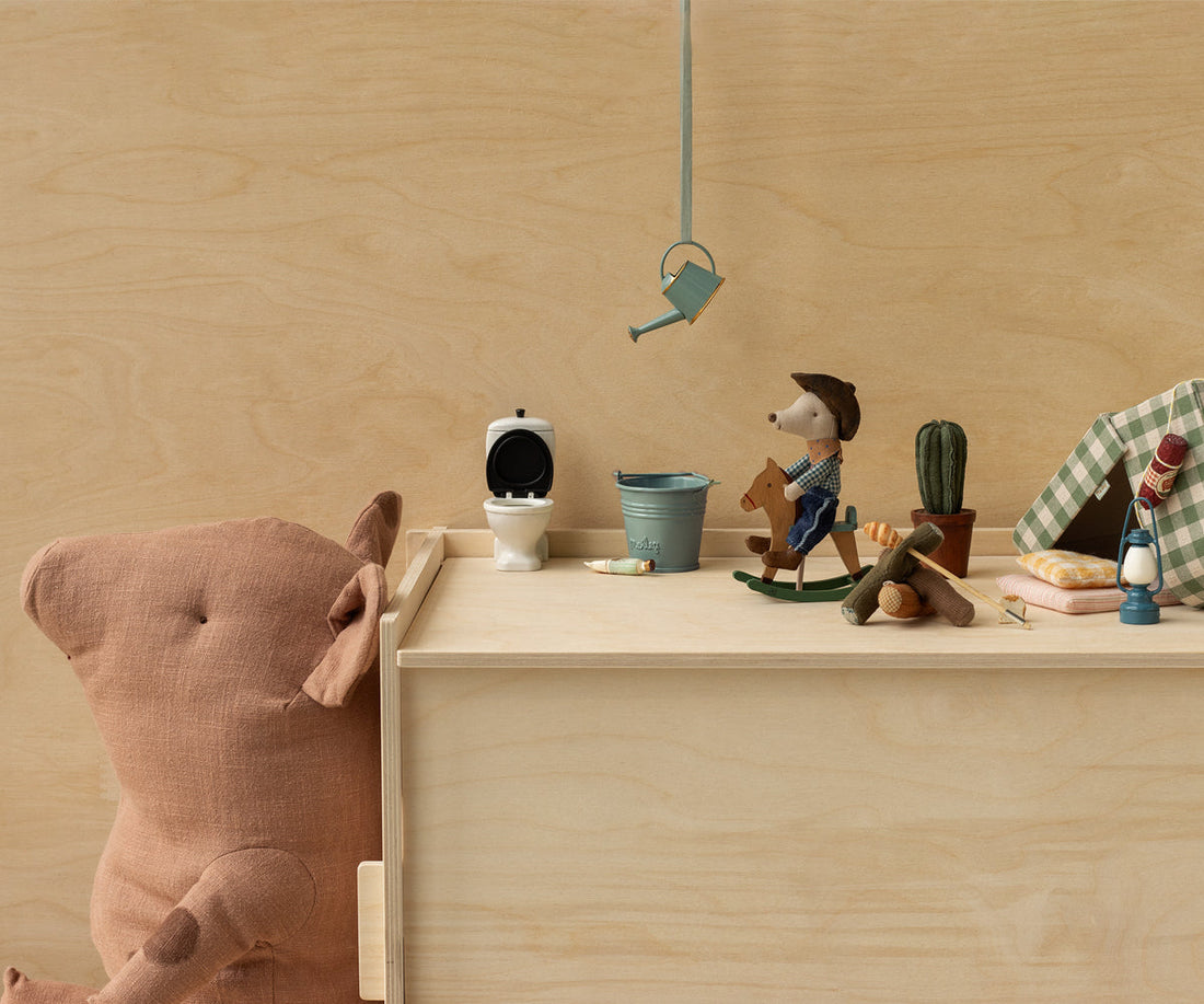 Wooden toy set with a bear, teddy bear, and other small items on a wooden surface.