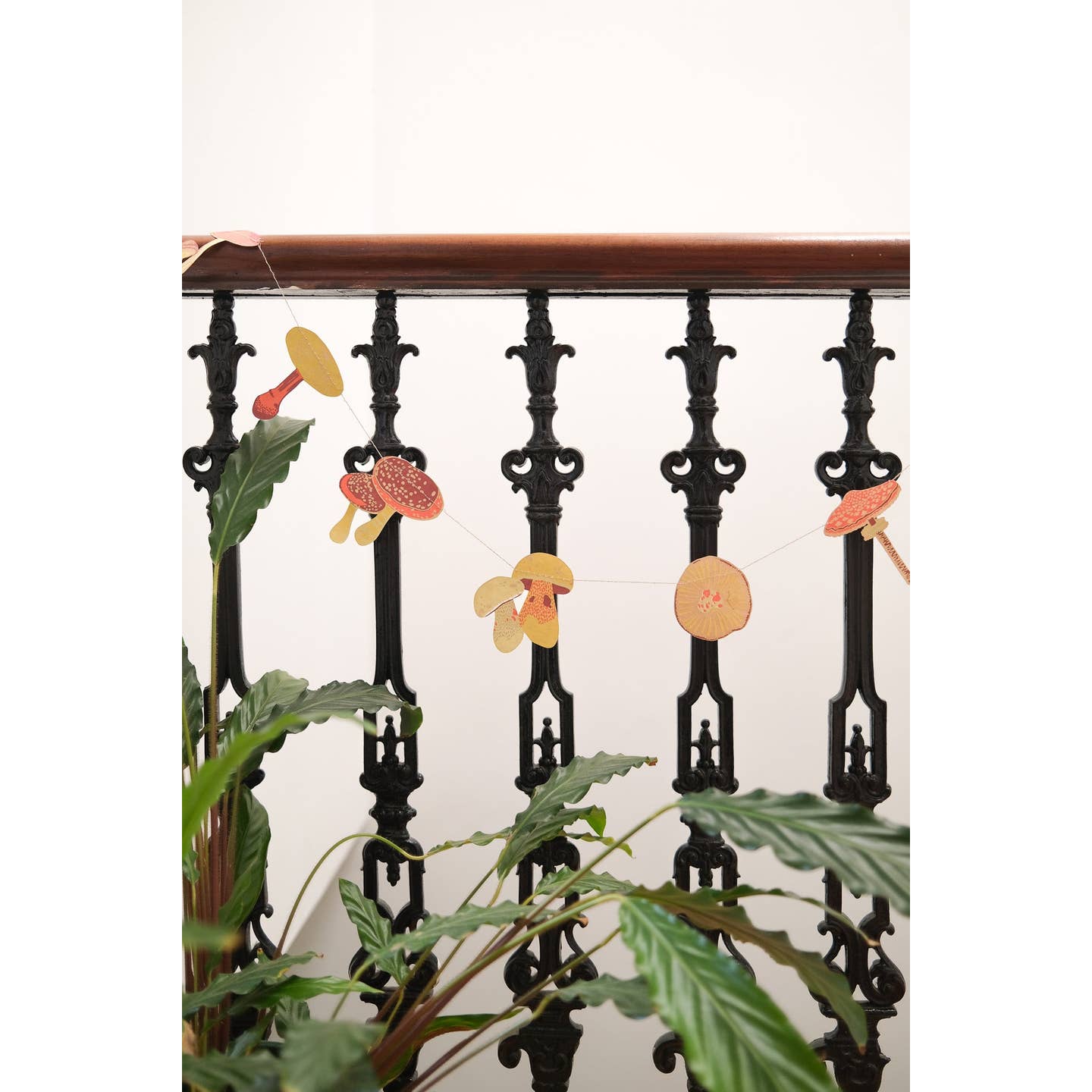Mushroom garland hanging on iron stairs.