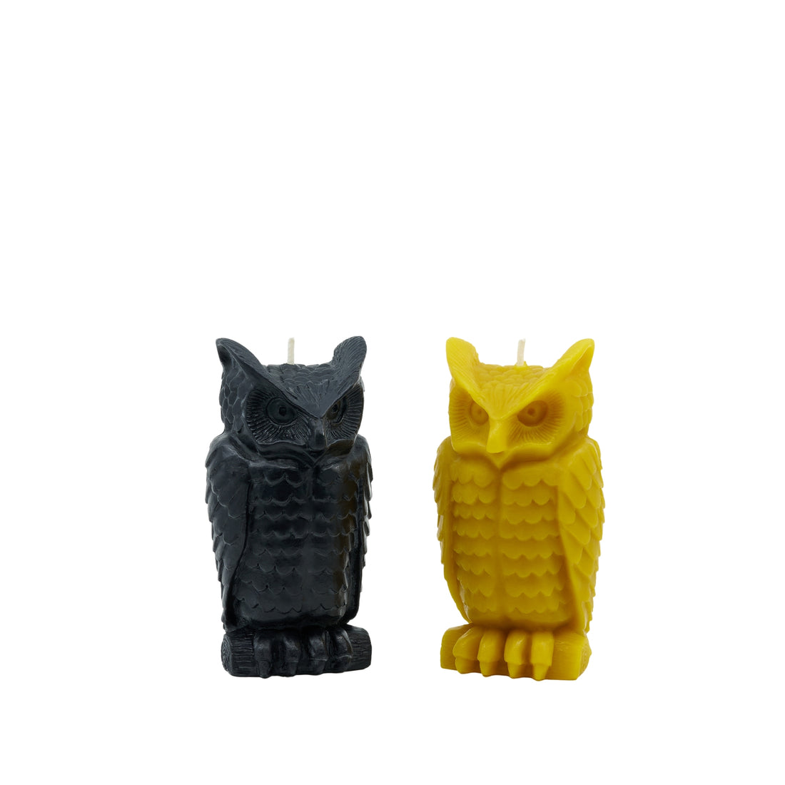 Two owl-shaped candles, one black and one yellow, made of beeswax with cotton wicks.