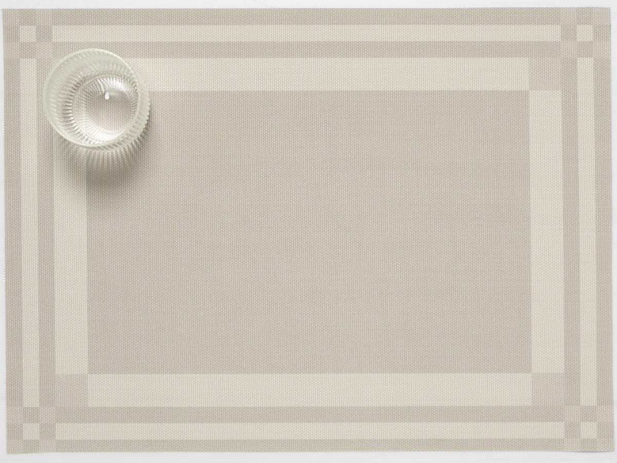 Flax color Handkerchief Compact Rectangle Placemat with a glass in the corner.