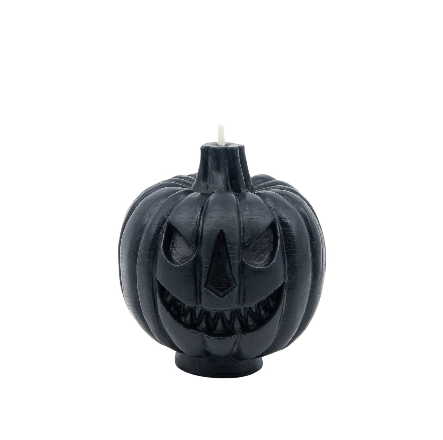 The scary face of a black jack-o-lantern candle.