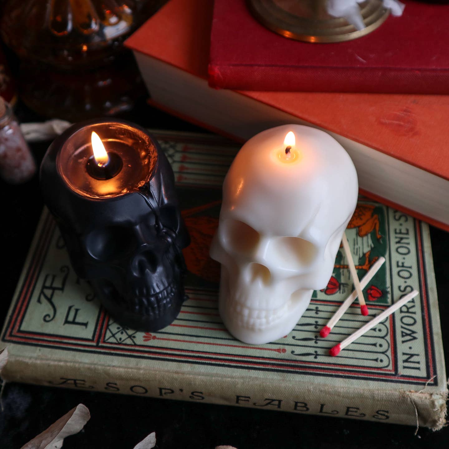 Black and cream skull shaped candle burning.