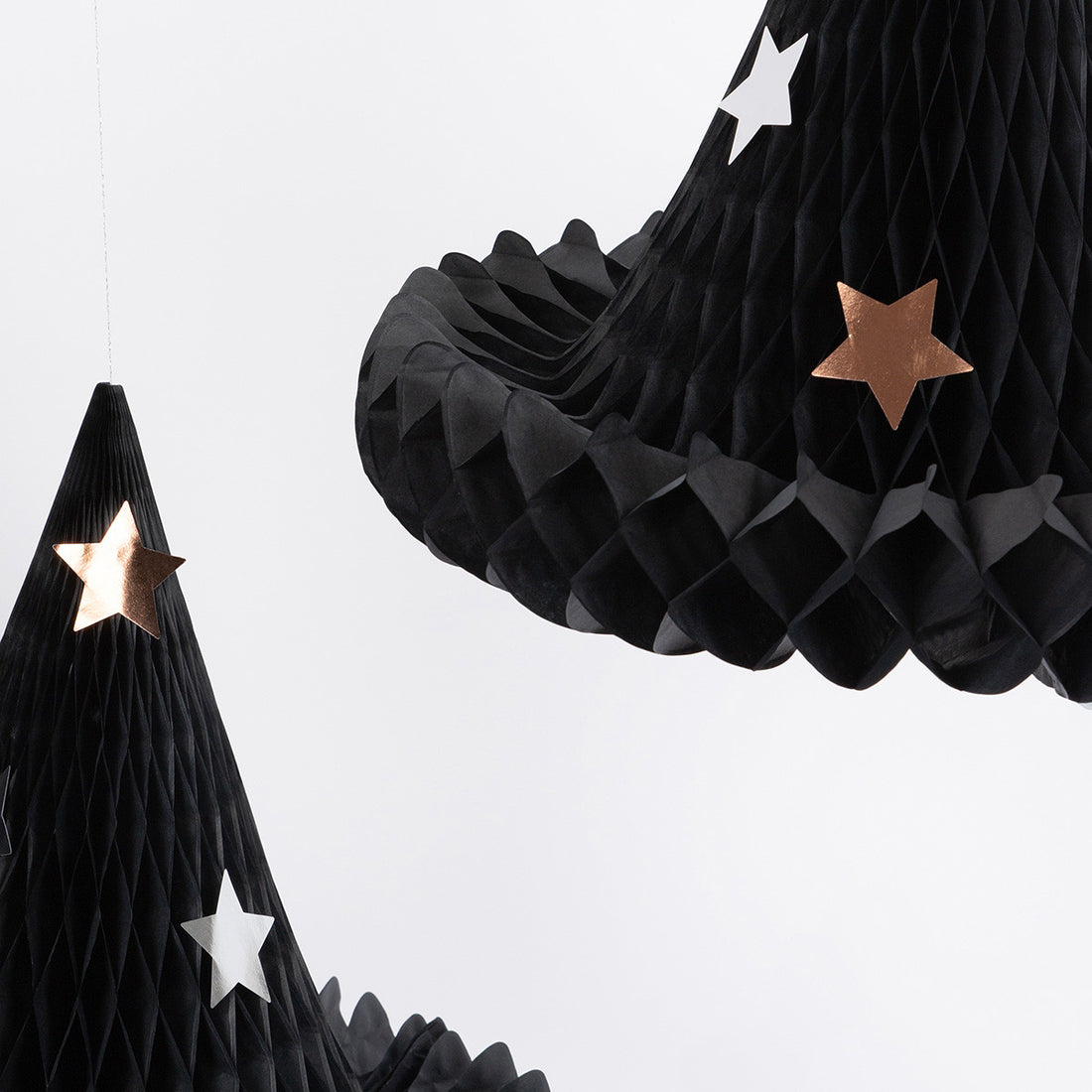 Black honeycomb decorations with star accents on a white background