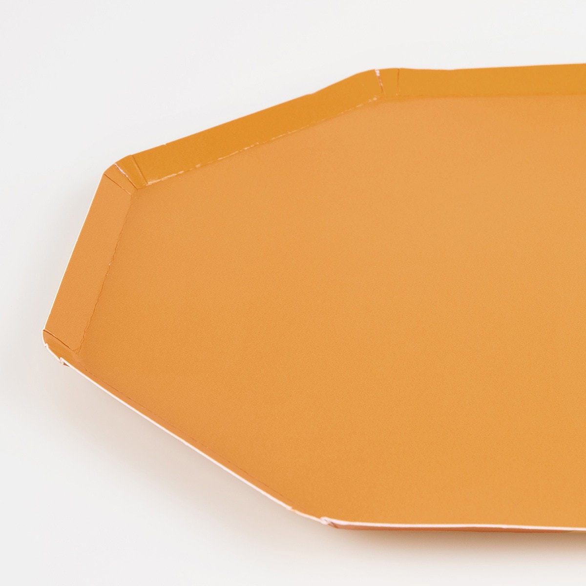 Octagonal yellow paper plate on a white background. 