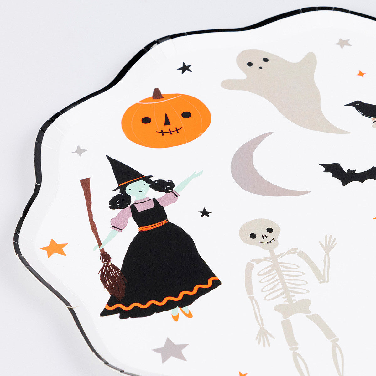 Halloween-themed paper plate with witch, pumpkin, ghost, skeleton, and bats on a white background.