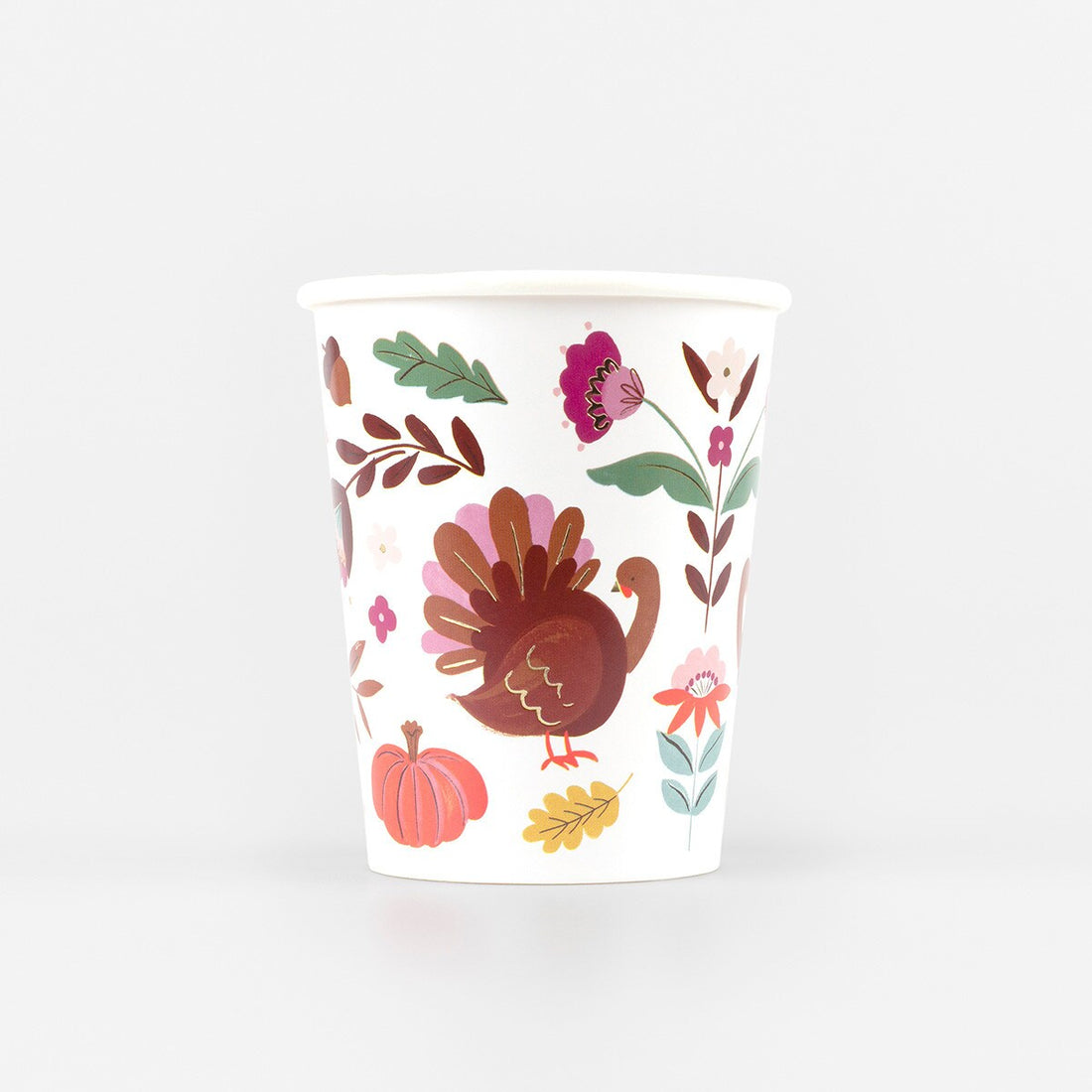 Paper cup with a Thanksgiving-themed design featuring a turkey, pumpkins, and leaves on a white background.