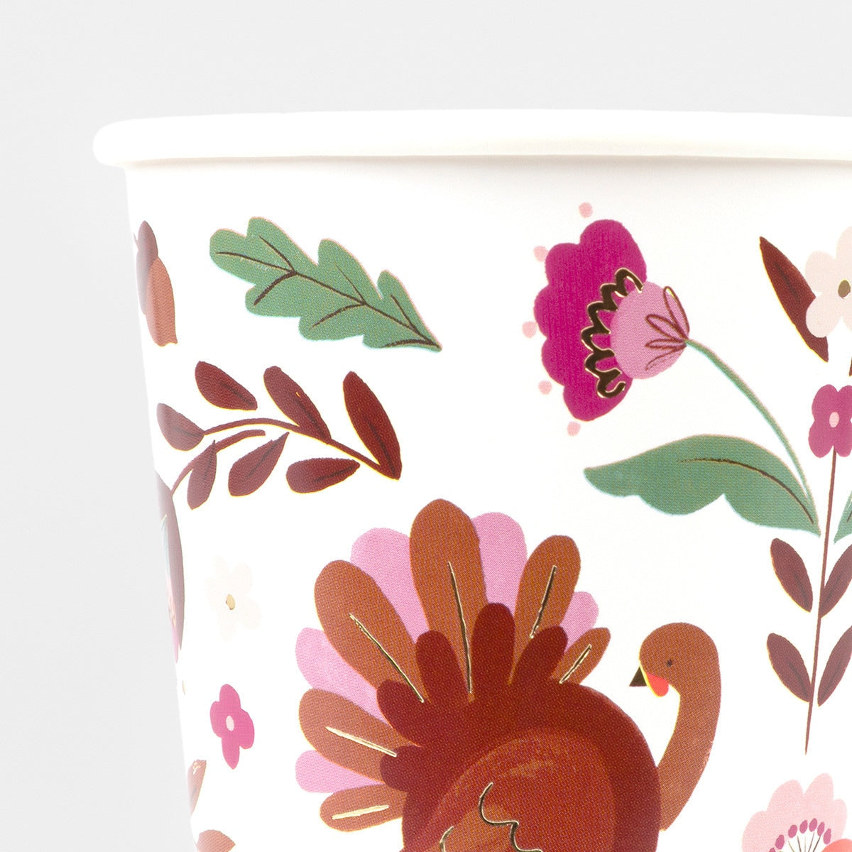 Floral and turkey design on a white background paper cup.