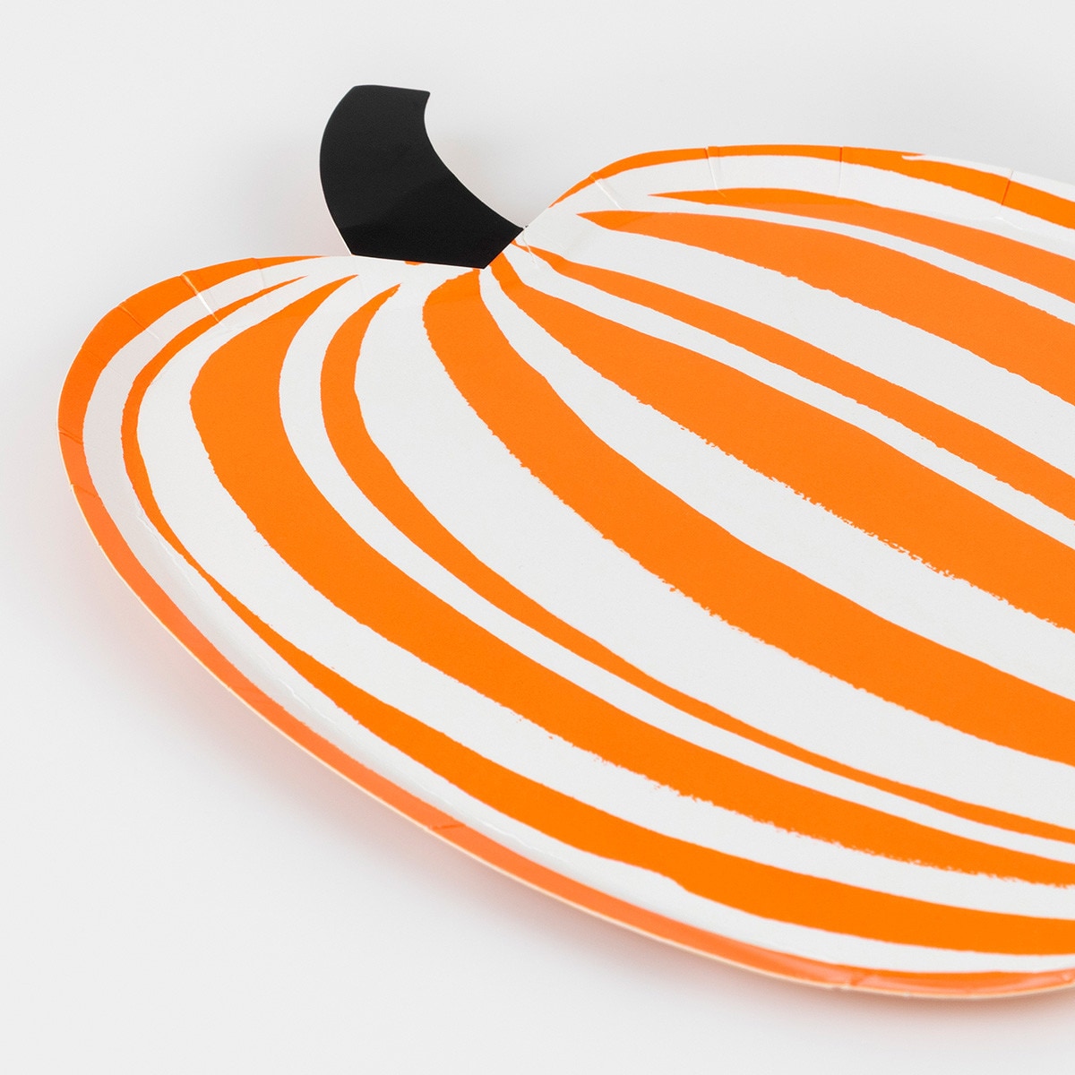 Decorative plate designed to look like a pumpkin with orange and white stripes on a white background.