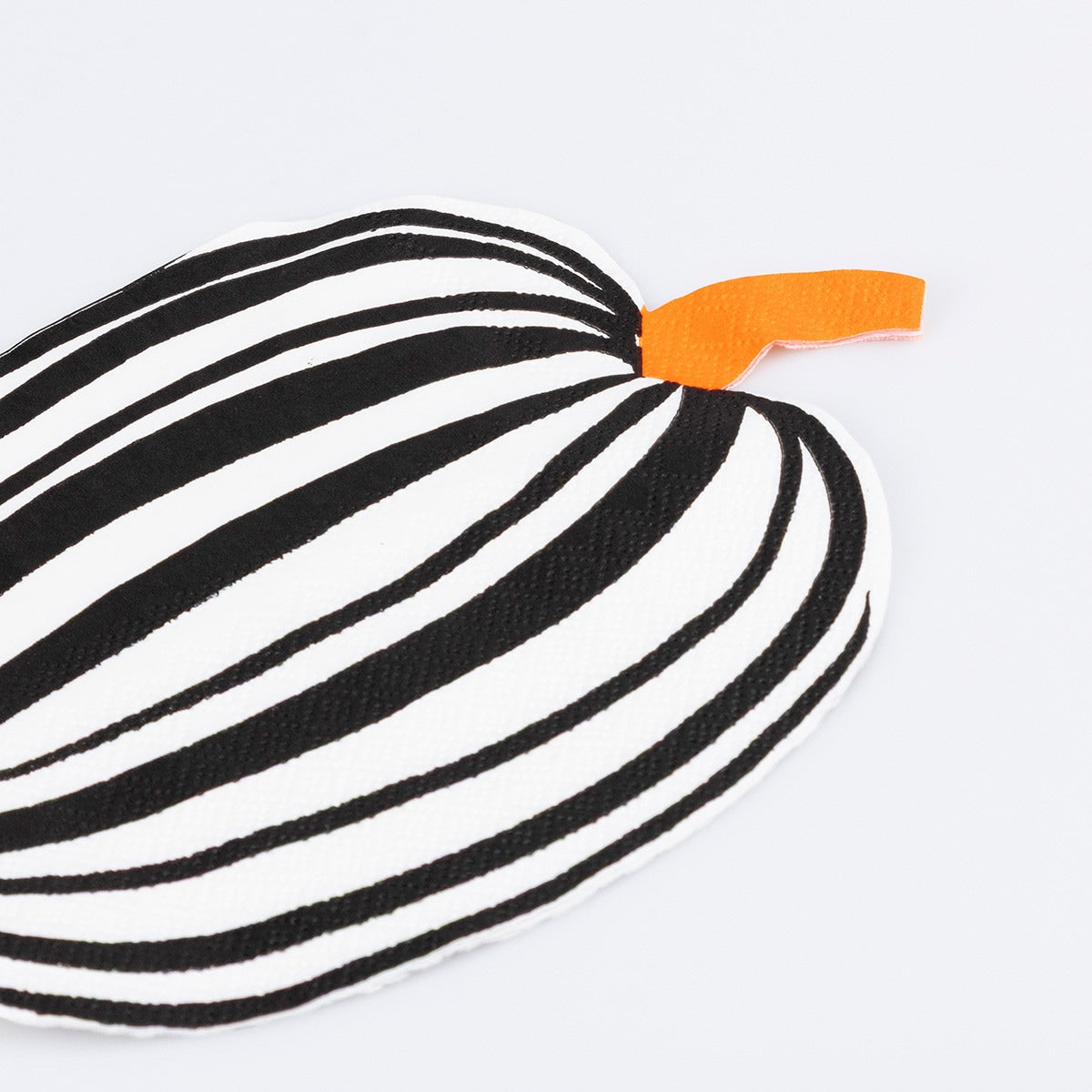 Black and white striped paper napkin with an orange tip on a light gray background.