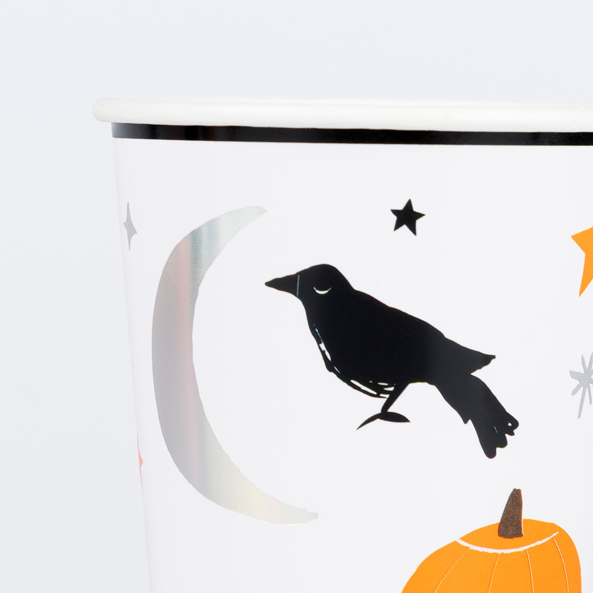 Halloween-themed paper cup with a black crow, orange pumpkin, and white moon on a white background.