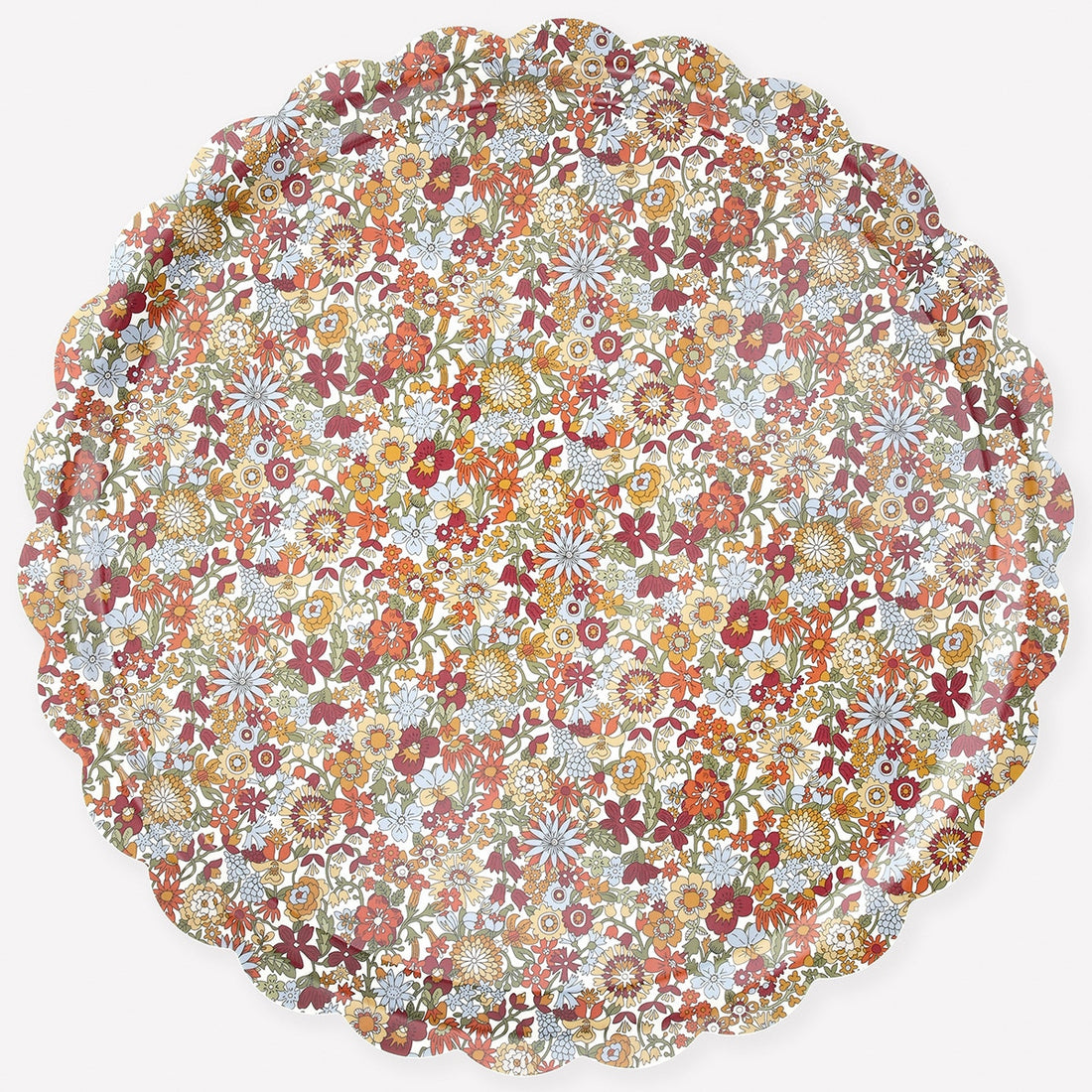 Round Liberty of London floral patterned tray with scalloped edge on a white background. 