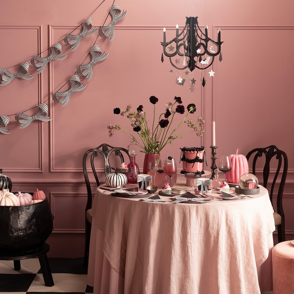 Dining room with Halloween-themed decor, including a table set with pumpkins and a chandelier.