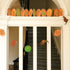 In bold greens and bright oranges, this garland features all the traditional images of Halloween - cats, ravens, spiders and pumpkins, shown hanging in a doorway. 