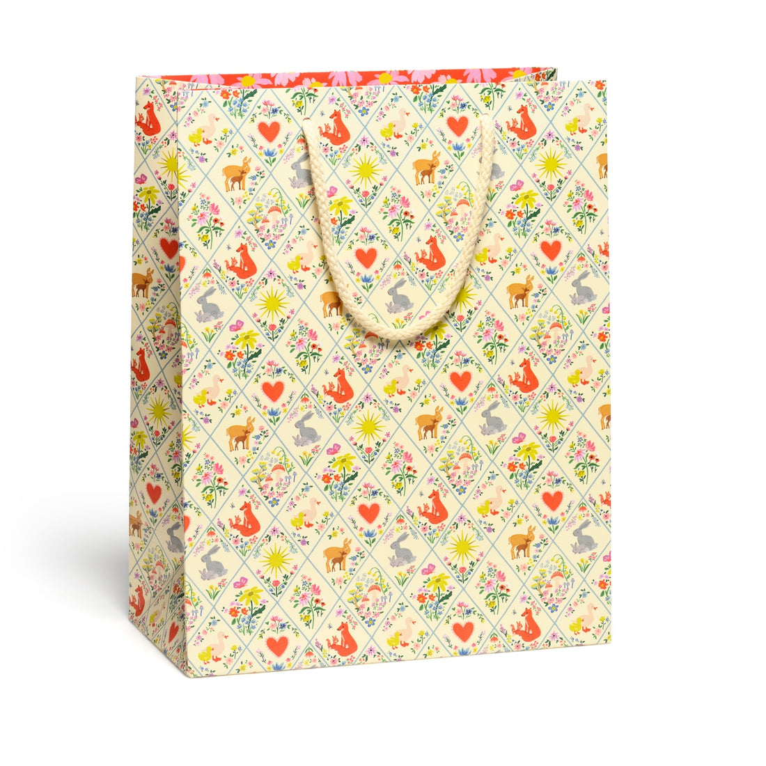 Gift bag with a colorful pattern of animals and flowers on a white background.