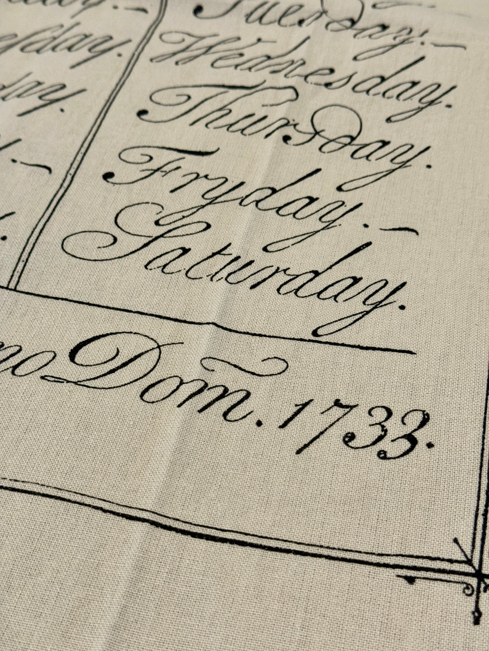 Close up of days of the week tea towel.