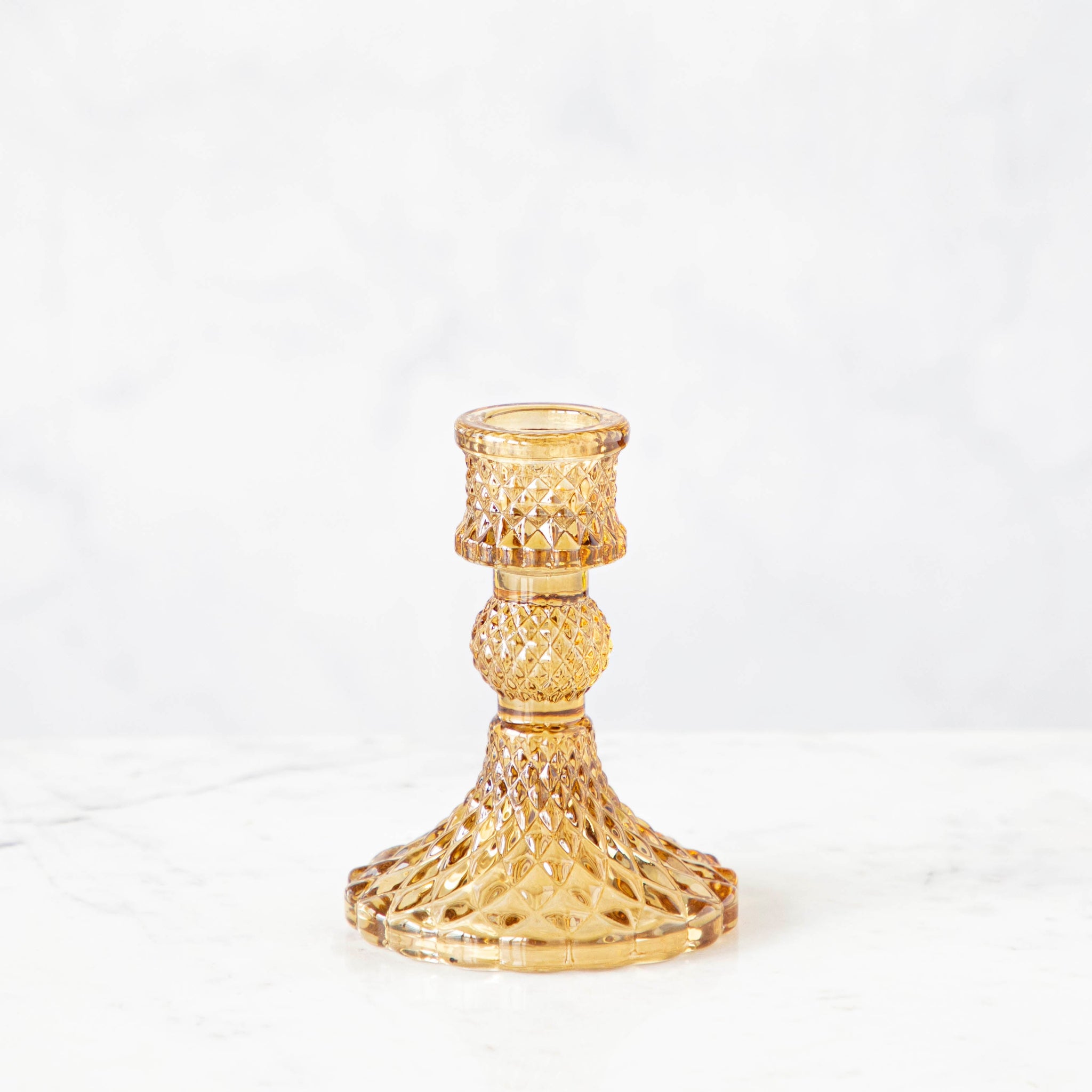 Vintage Amber Candlestick holder on a white background.