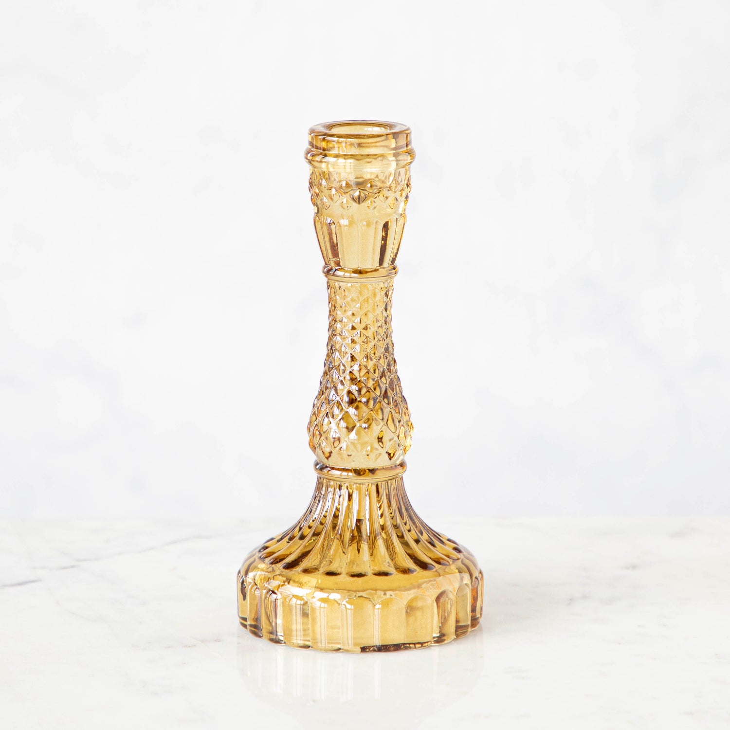 Vintage Amber Candlestick holder on a white background.