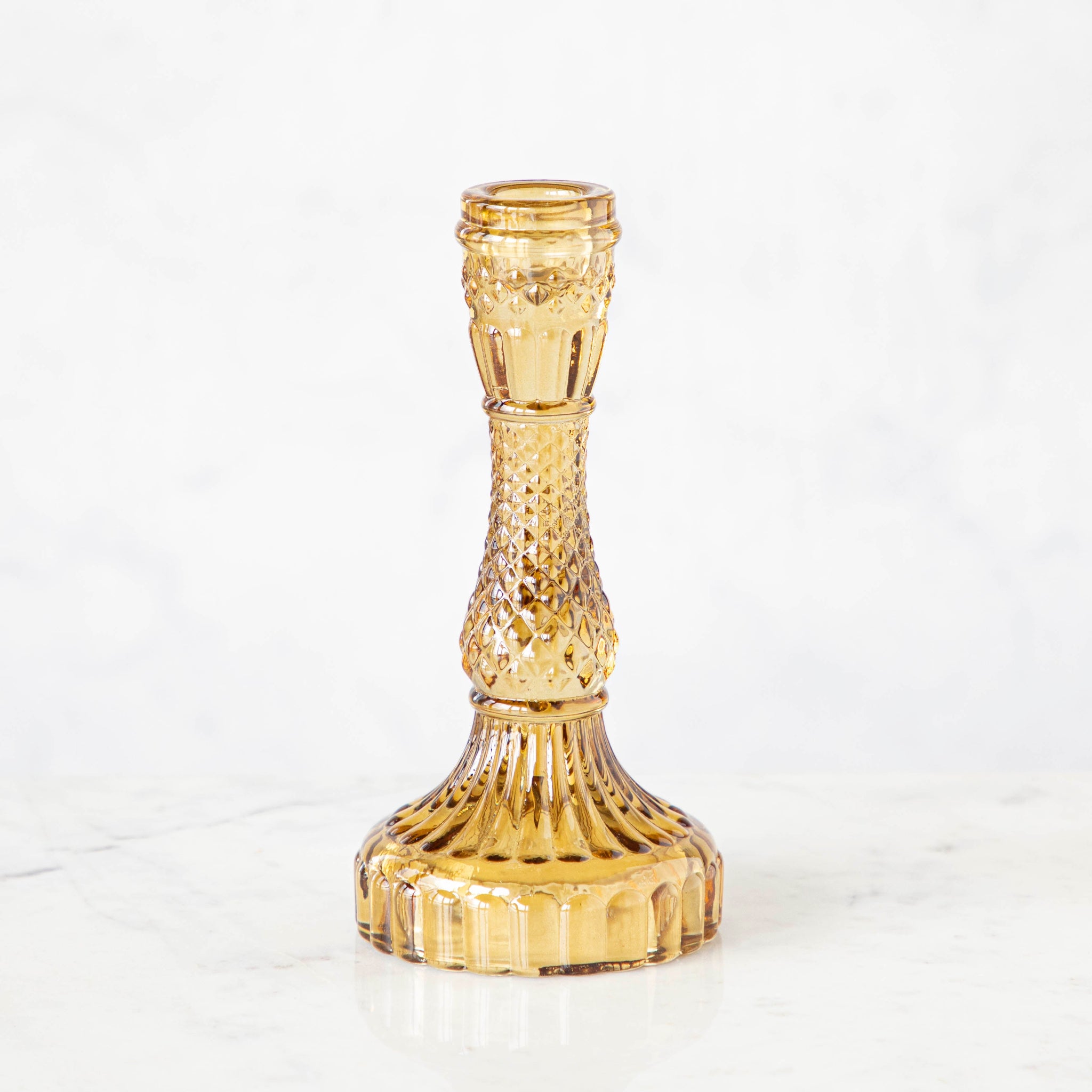 Vintage Amber Candlestick holder on a white background.
