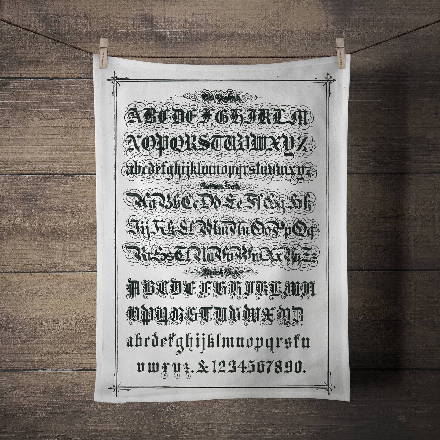 Tea towel with the alphabet written out on it in Old English style lettering and font. 