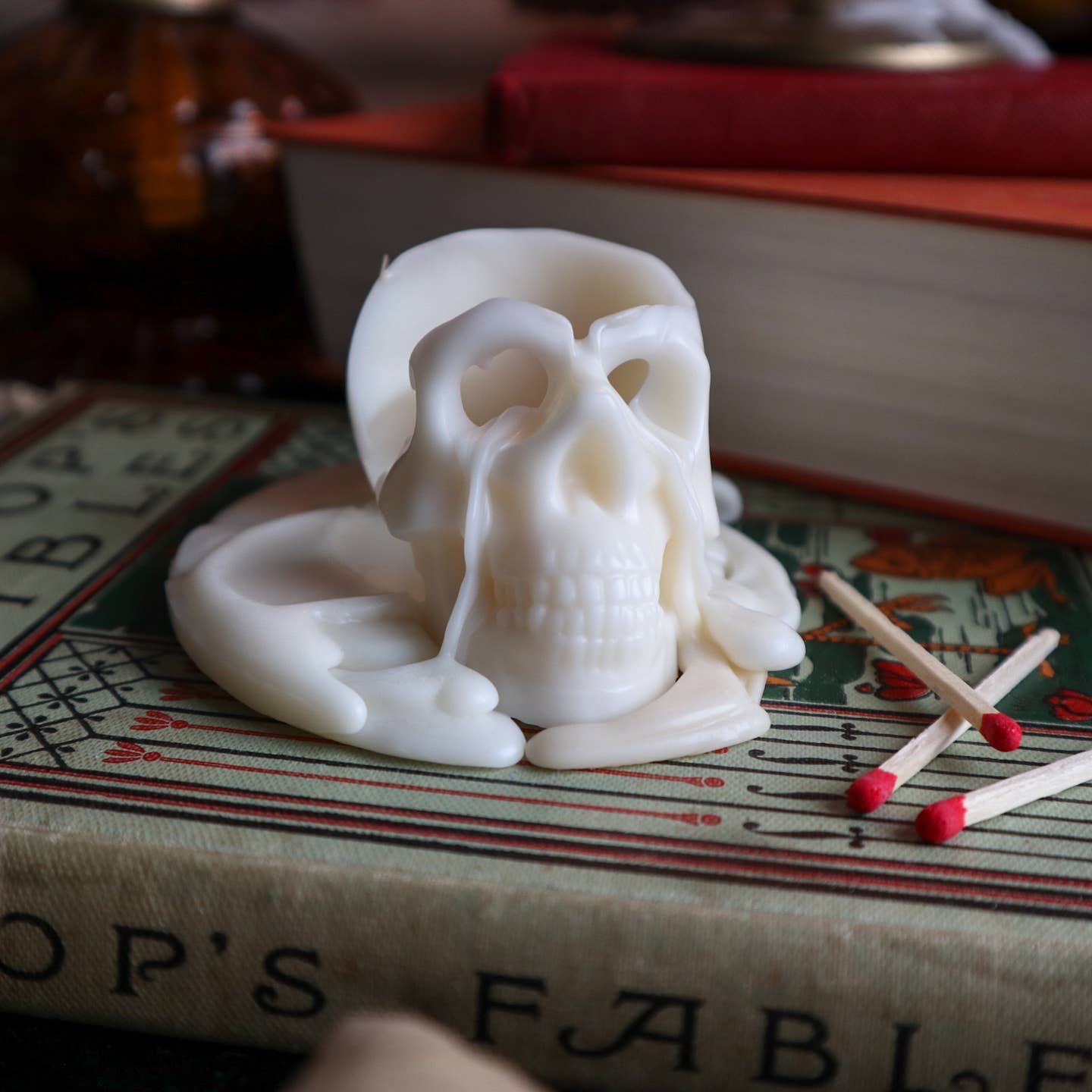 Cream skull shaped candle burning. 