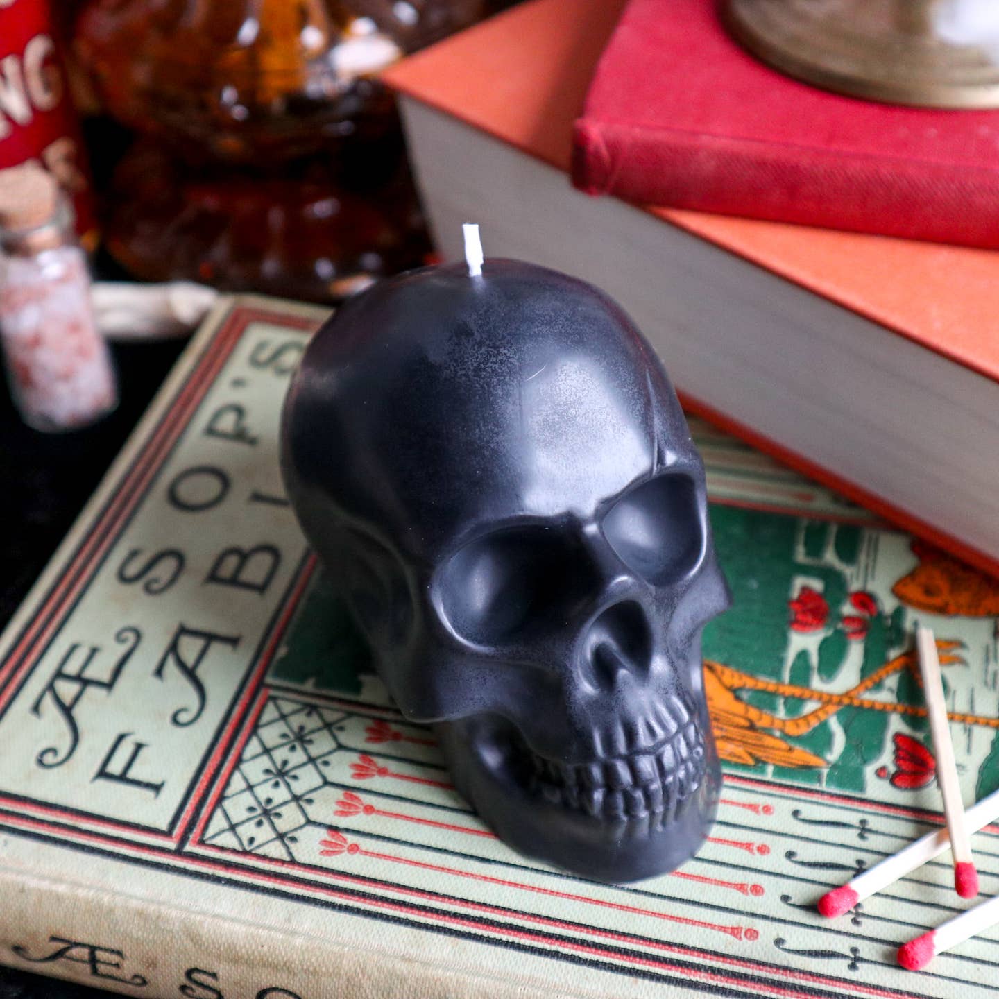 Black skull shaped candle burning. 