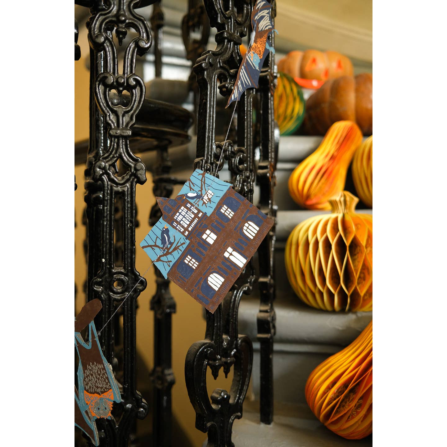 Haunted house garland hanging on a metal staircase.