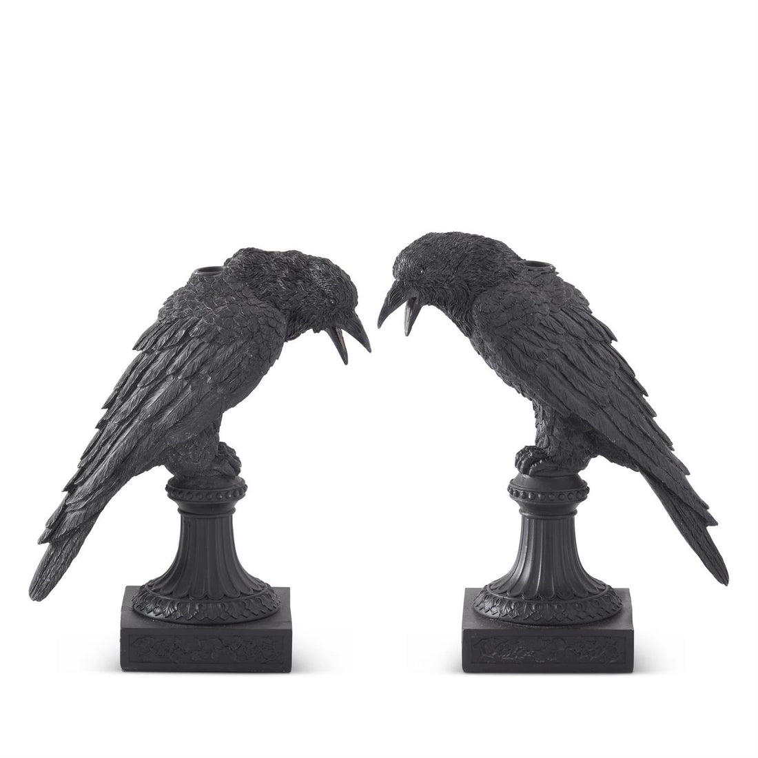 Two Black Resin Crow Taper Candleholders featuring black crows perched on a post with a square base and a spot in their backs for a taper candle.