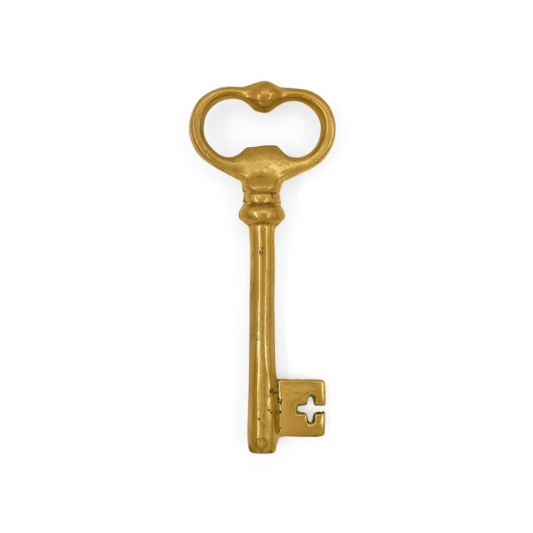 Decorative gold key bottle opener on a white background.