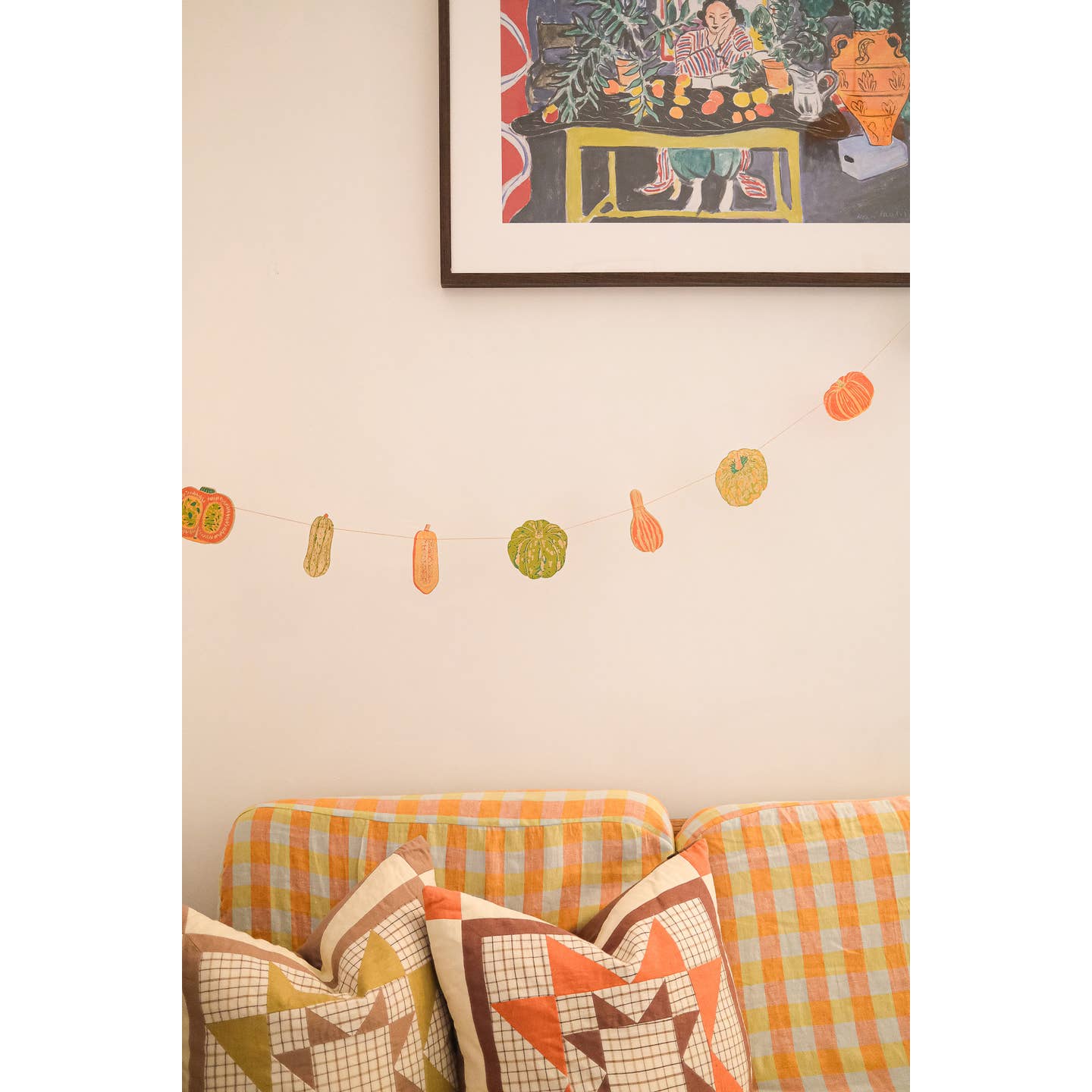Squashes garland hanging above a couch.