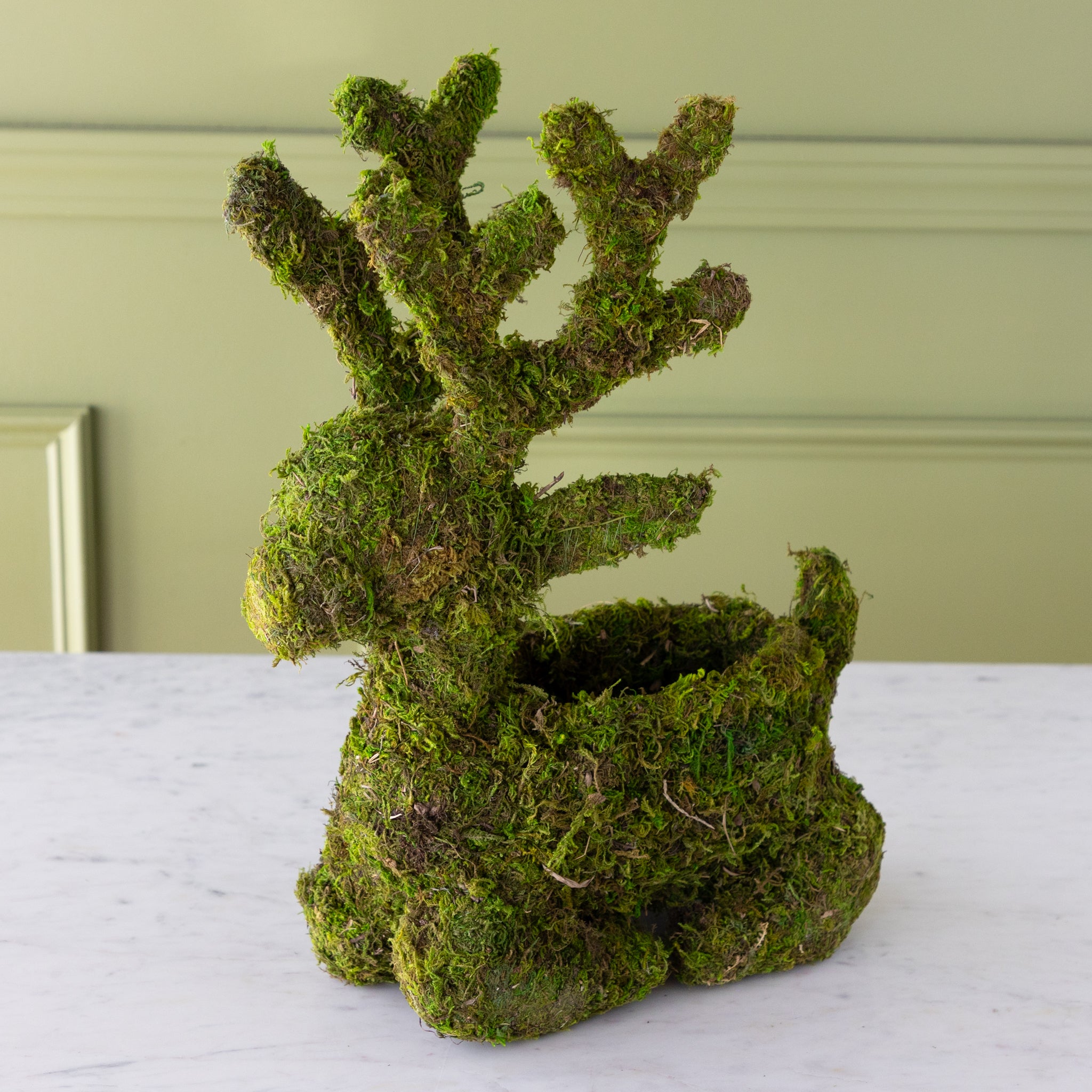 Sitting moss-covered reindeer planter with a space in it&