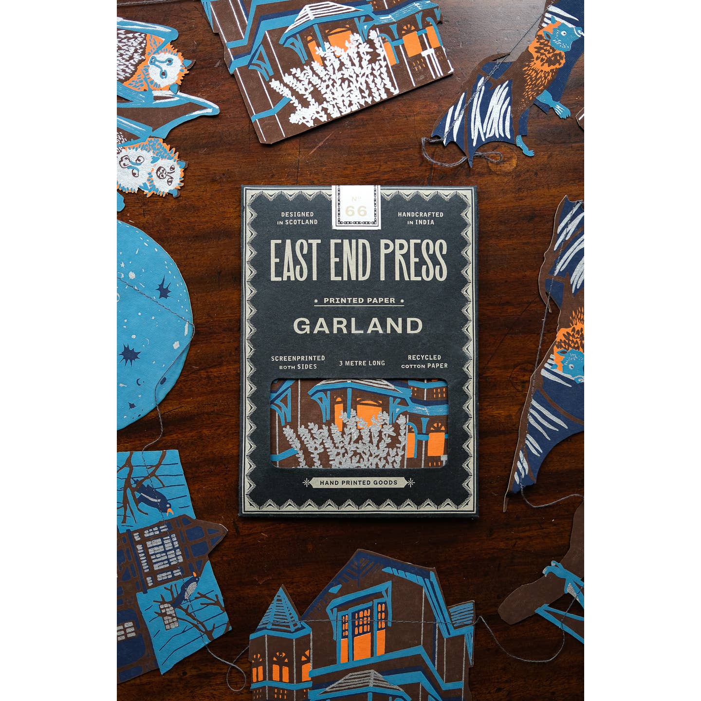 Package of the Haunted House sewn garland on a table surrounded by the garland.