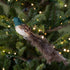 Decorative bird ornament on a Christmas tree with lights.
