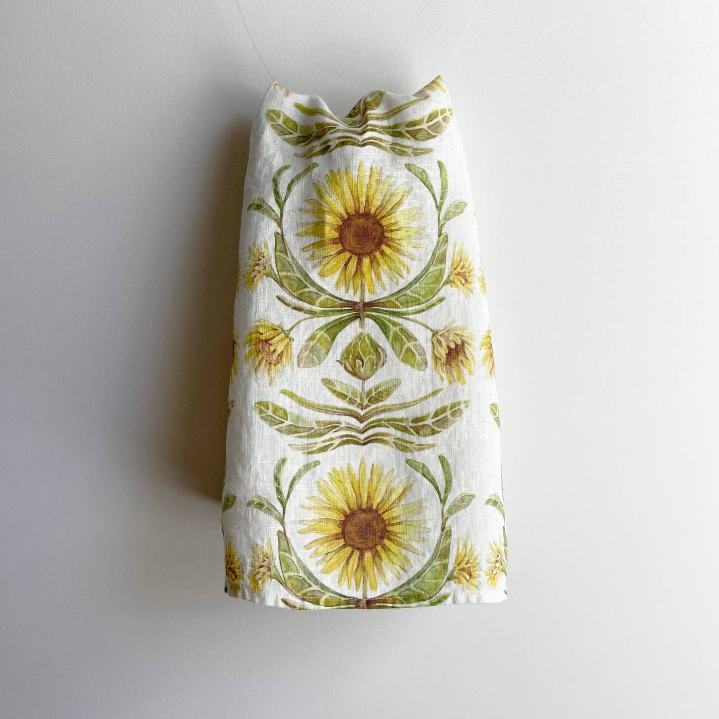 Tea towel with sunflower pattern on a plain background