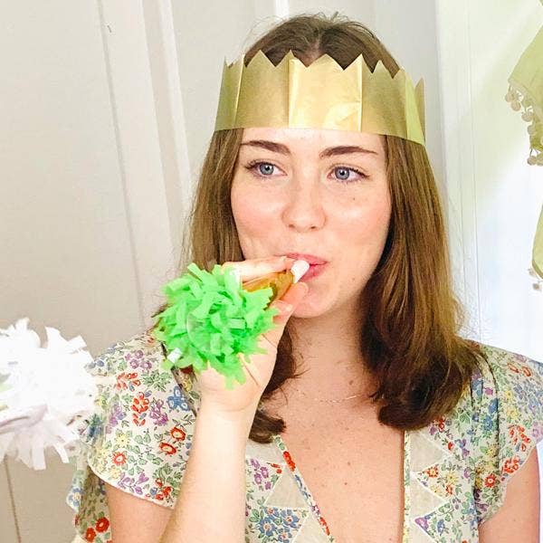Woman wearing a gold paper crown.