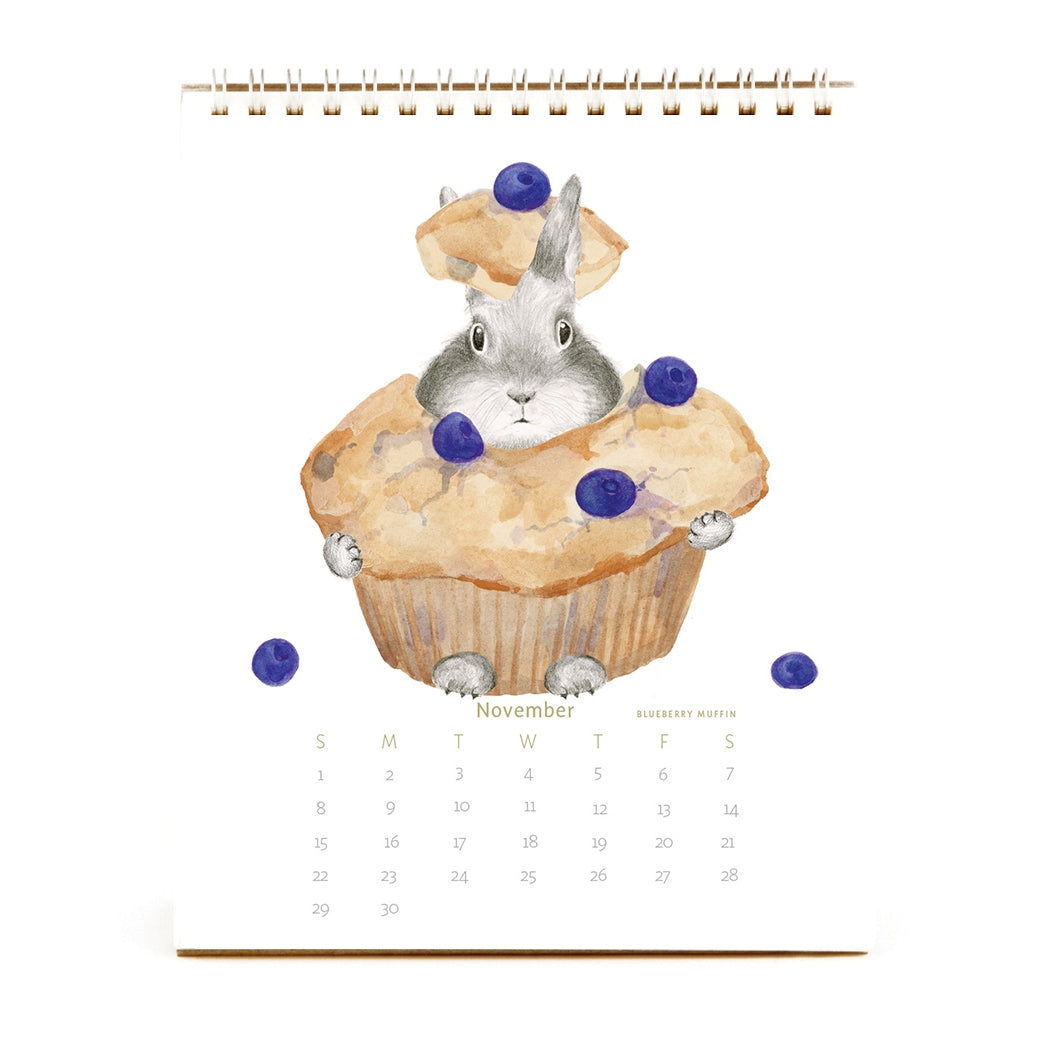 2026 Dear Hancock Bunny Calendar featuring a bunny hidden in a blueberry muffin.