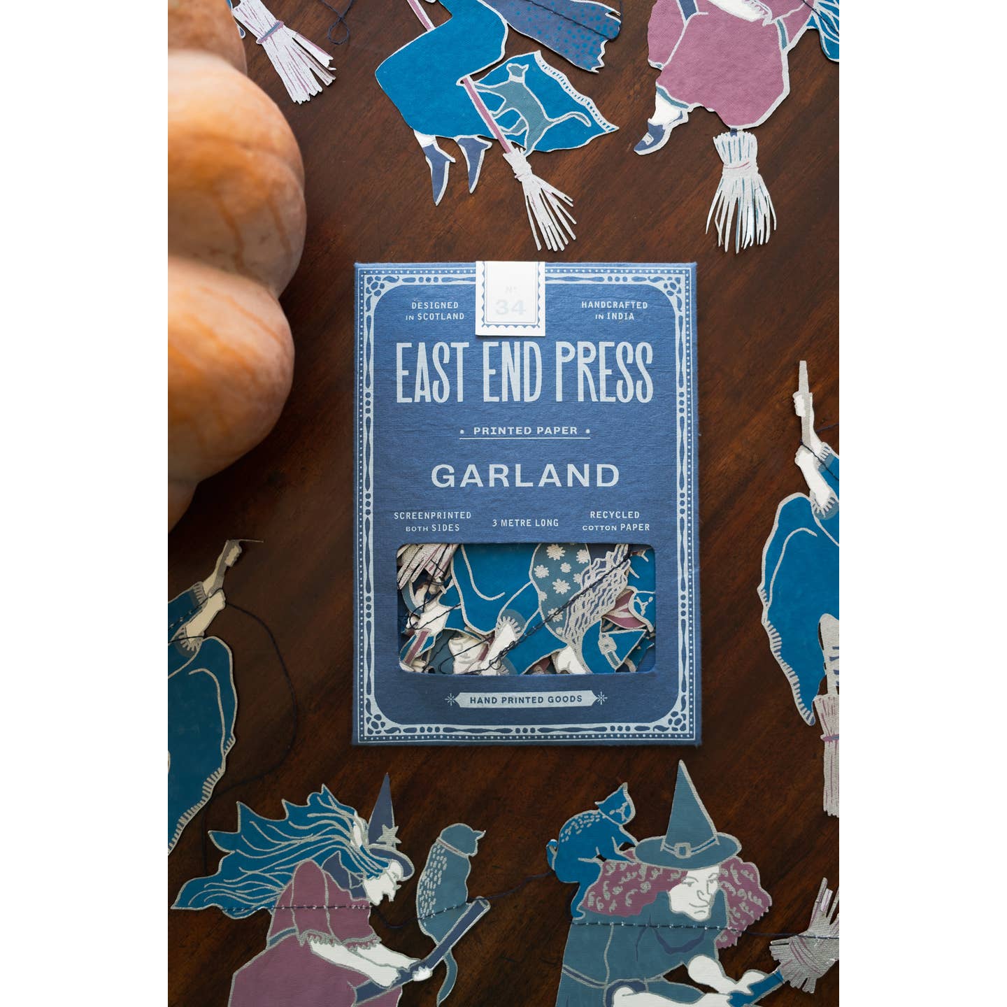 Front of package for the witches garland surrounded by the witches garland.