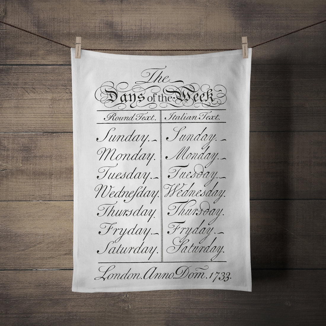 Days of the week tea towel featuring the days of the week listed written in elaborate script lettering. 