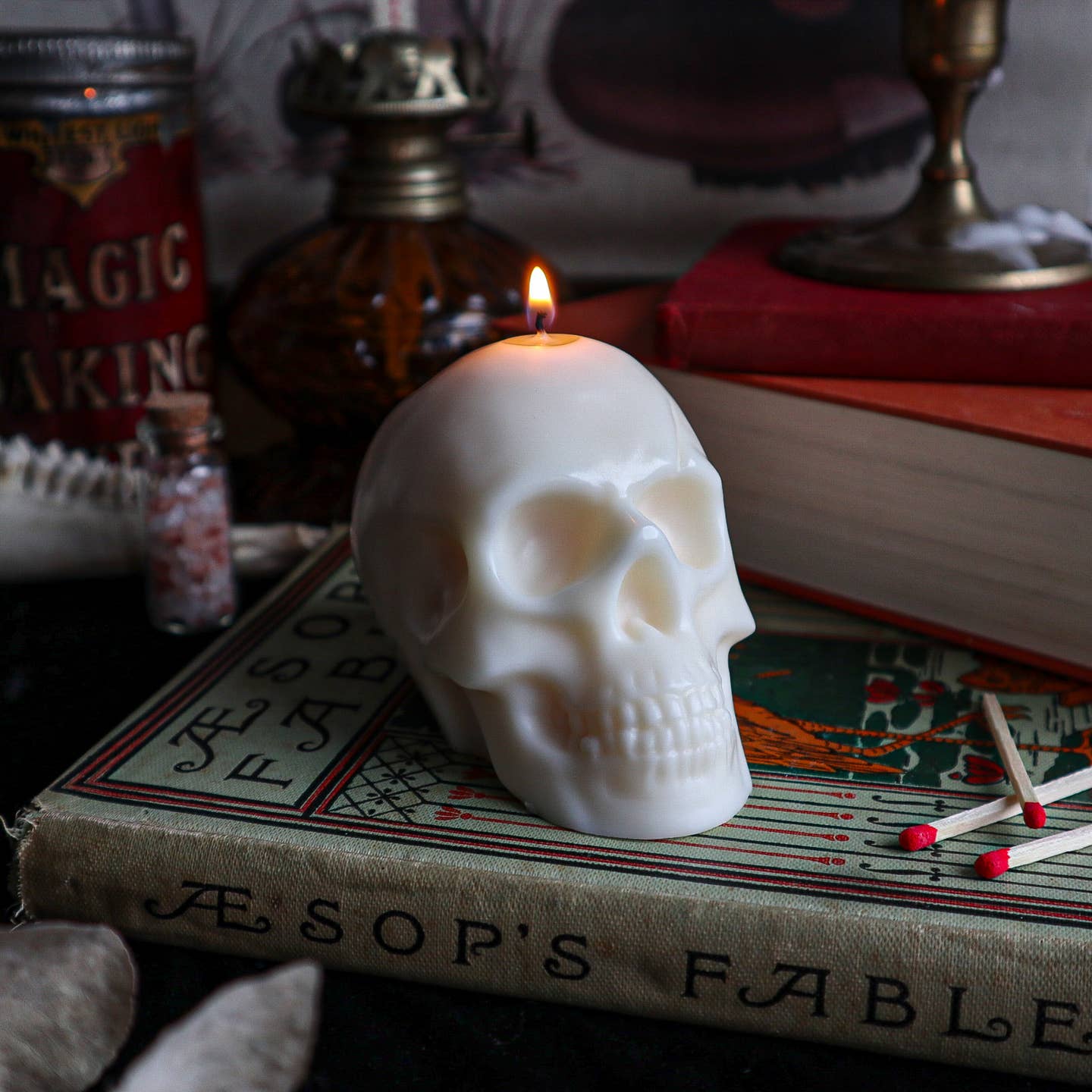 Cream skull shaped candle burning.