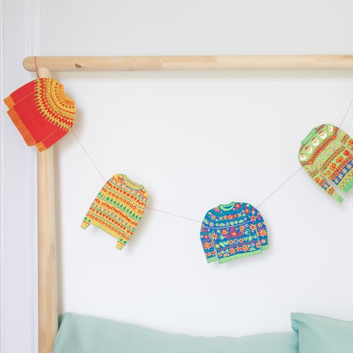 Close up of the sweater garland draped over a pole.