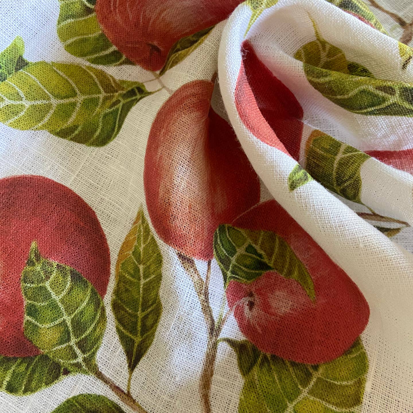 Fabric with red apple and green leaf pattern