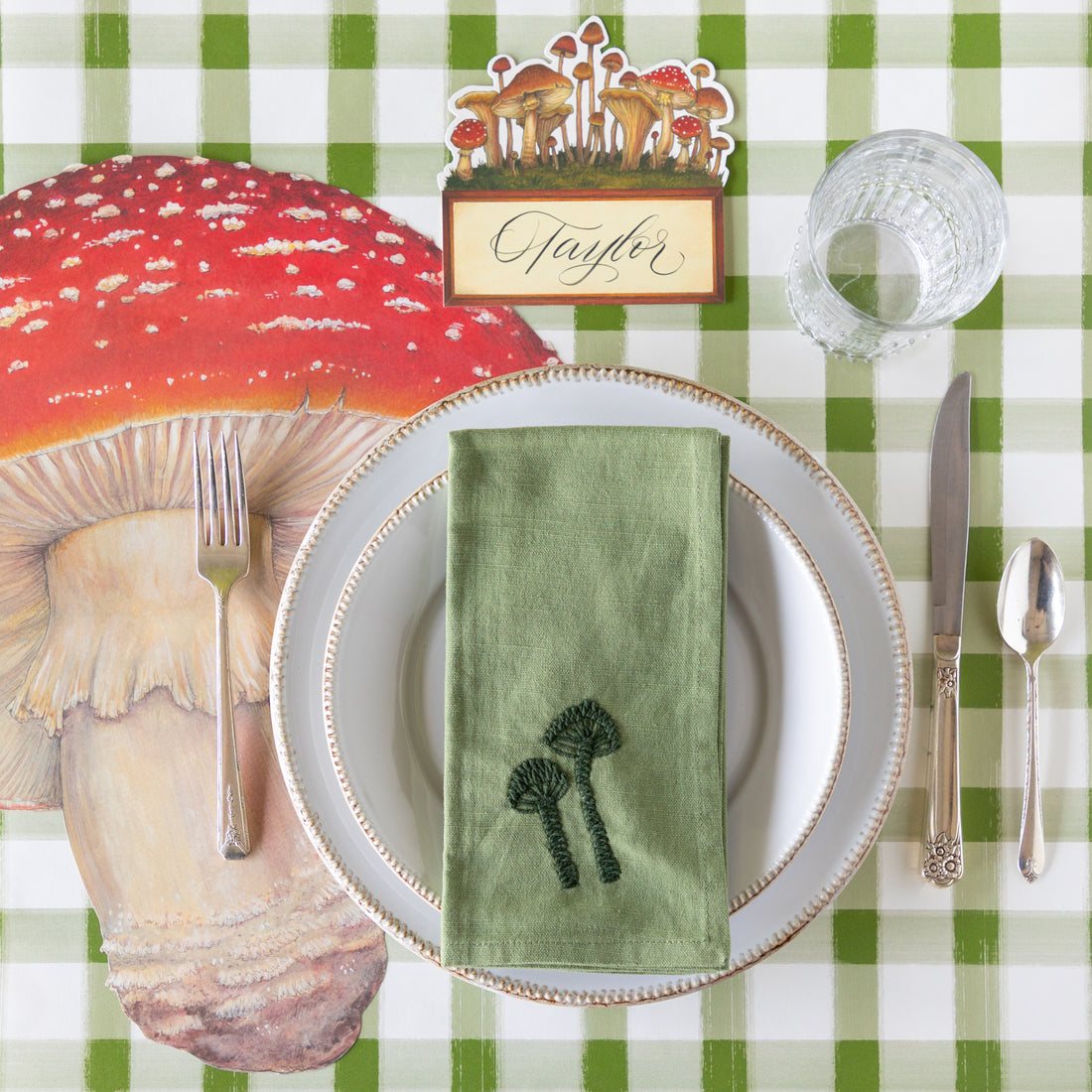 Mushroom-themed place setting with the Embroidered Mushroom Napkin resting on the plates.