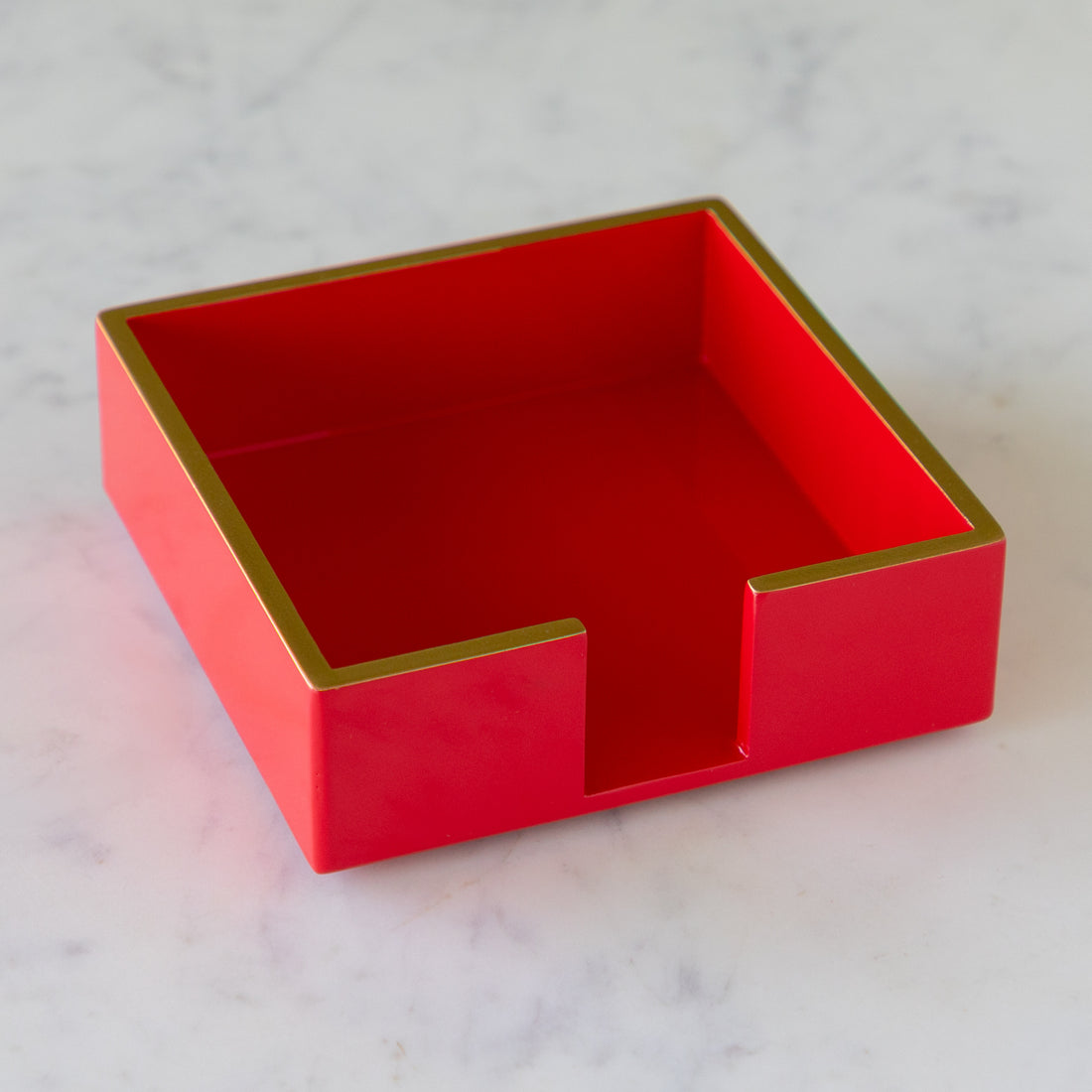 Beverage Napkin Holder in red with gold trim in cocktail size.